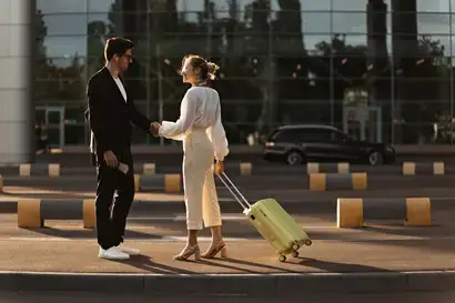 Driver fetching woman from airport with luxury vehicle shuttle