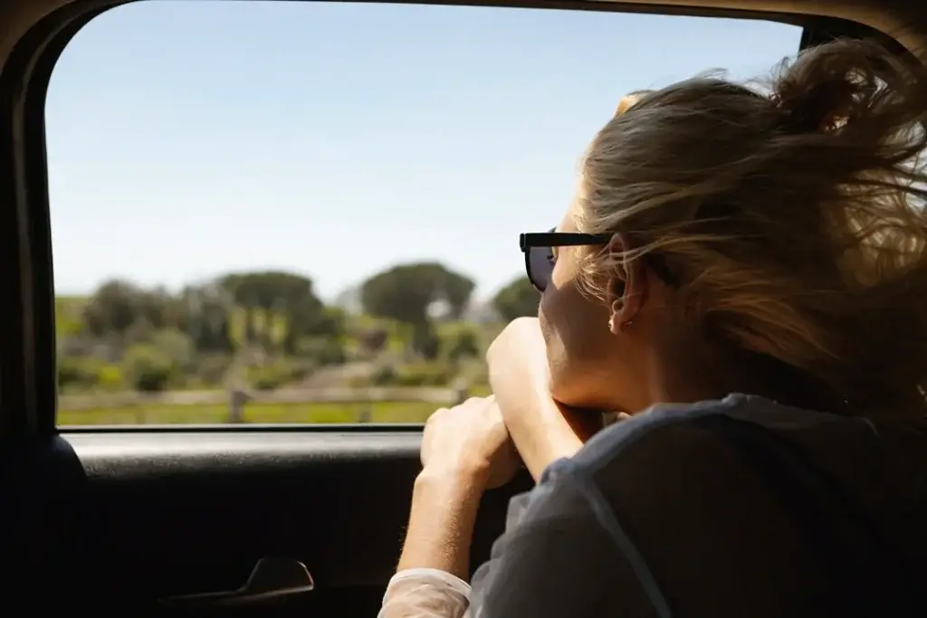 female passenger staring out of window while on a private shuttle tour
